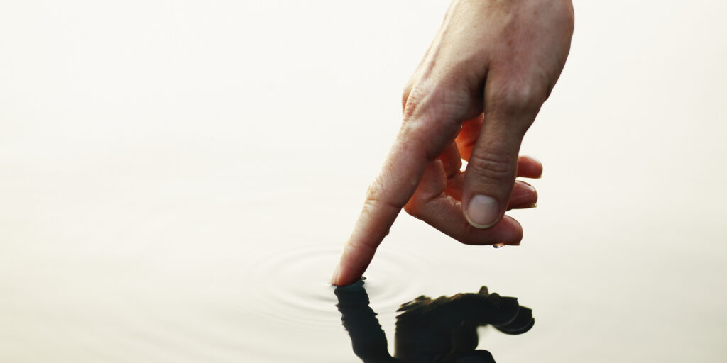 A finger touching water
